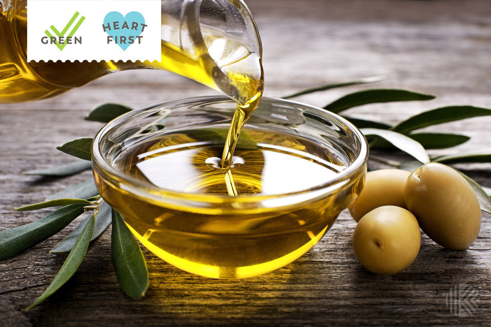 Bottle pouring virgin olive oil in a bowl